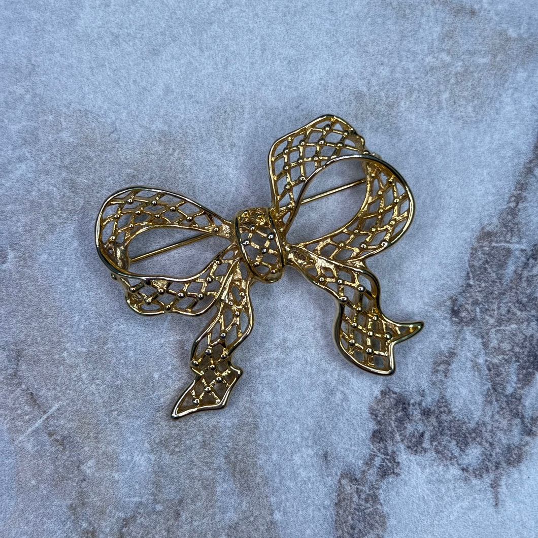 Broche boucle festive dorée